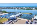 Expansive aerial view of a marina community, with boat docks, modern condos, and tranquil waters in the background at 7070 Placida Rd # 1230, Placida, FL 33946