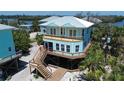 Beautiful coastal house with decks, surrounded by lush tropical landscape at 8152 Little Gasparilla Is, Placida, FL 33946