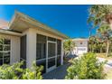 Enclosed screened porch overlooking a lush yard providing a relaxing space for outdoor enjoyment and privacy at 941 Allen Ave, Englewood, FL 34223