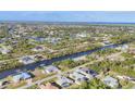 Expansive aerial view of the community with canals, homes, and lush landscaping stretching towards the horizon at 15184 Aldama Cir, Port Charlotte, FL 33981