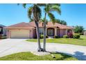Inviting single-story home with a well-manicured lawn and circular driveway at 1080 Boundary Blvd, Rotonda West, FL 33947