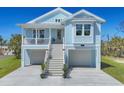 Charming two-story home with inviting staircase and double garage and a charming balcony at 1141 Andrews St, Englewood, FL 34224