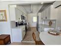 Bright kitchen with white cabinets, stainless steel appliances, and tile floors at 1270 Gulf Blvd # A&B, Englewood, FL 34223