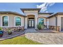 Inviting home entrance with stone accents and manicured landscaping at 14527 Maysville Cir, Port Charlotte, FL 33981
