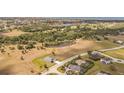 Expansive aerial shot showcasing a neighborhood near the water, with large properties and surrounding greenery at 16489 Trading Post Rd, Punta Gorda, FL 33955