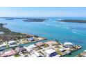 Aerial view of canal front homes and clear blue water on a sunny day at 1905 Pennsylvania Ave, Englewood, FL 34224