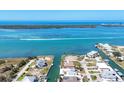 Aerial view of the neighborhood with canal front homes and clear blue water and beautiful island at 1905 Pennsylvania Ave, Englewood, FL 34224