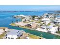 Aerial view of homes with boat docks on a canal with waterway in the distance at 1905 Pennsylvania Ave, Englewood, FL 34224
