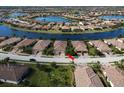 Beautiful aerial view of the home and surrounding community with tranquil lakes and lush landscaping at 20171 Tesoro Dr, Venice, FL 34293