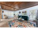 Spacious living room featuring wood ceilings, plenty of natural light, and stylish furnishings at 2033 Georgia Ave, Englewood, FL 34224