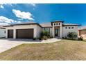 This attractive single-Gathering home boasts a three-car garage, well-kept lawn, and brick paver driveway at 212 Rotonda E Blvd, Rotonda West, FL 33947
