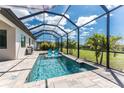 Sparkling screened-in pool features two chairs, tropical landscaping, and plenty of space for relaxing at 212 Rotonda E Blvd, Rotonda West, FL 33947