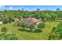 Expansive property featuring a large lawn, mature trees, and a screened-in pool at 2700 Sheboygan Ave, North Port, FL 34286