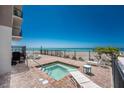 A tranquil outdoor jacuzzi sits next to the ocean, with lounge chairs for relaxing at 2792 N Beach Rd # 301, Englewood, FL 34223