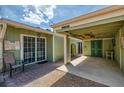 Exterior of home featuring carport, brick paved patio, and pale-green painted exterior walls at 2980 N Beach Rd # Gv16, Englewood, FL 34223