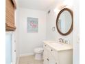Charming bathroom features a vanity with elegant mirror, toilet, and stylish accents at 301 S Gulf Blvd # 419, Placida, FL 33946