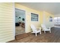 Charming porch with Adirondack chairs leading into a bright living space at 342 S Gulf Blvd, Placida, FL 33946