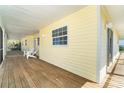 Expansive yellow porch with white Adirondack chairs offering a relaxing outdoor space at 342 S Gulf Blvd, Placida, FL 33946