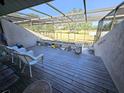Enclosed patio with view of golf course, potted plants, and outdoor seating at 351 Bobby Jones Rd # 351, Sarasota, FL 34232