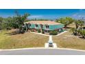 Expansive view of a two-story condo complex featuring unique architecture and beautiful surrounding landscaping at 3586 Cape Haze N Dr # B6, Rotonda West, FL 33947