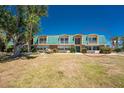 Inviting two-story condo with a vibrant green roof and lush landscaping with a private balcony for outdoor enjoyment at 3586 Cape Haze N Dr # B6, Rotonda West, FL 33947