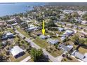 Aerial view of a single-story home near a bay in a residential neighborhood at 360 W Cowles St, Englewood, FL 34223