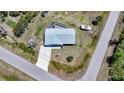 Aerial view of a home with a driveway, boat, and deck surrounded by lush greenery at 5460 Norlander Dr, Port Charlotte, FL 33981