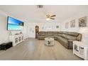 Bright living room with a large sectional sofa, TV, and beach-themed decor at 5460 Norlander Dr, Port Charlotte, FL 33981