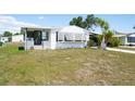 Charming single-story home with a well-maintained lawn and convenient covered parking at 6168 Partridge Ave, Englewood, FL 34224