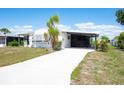 Well-maintained single-story home with covered carport and spacious driveway at 6168 Partridge Ave, Englewood, FL 34224
