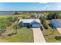 An aerial view of a single-Gathering home showcasing its manicured lawn and neighborhood at 7360 David Blvd, Port Charlotte, FL 33981