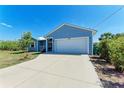 Beautiful house with an attached two-car garage and a well-manicured yard at 7360 David Blvd, Port Charlotte, FL 33981