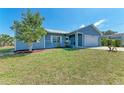 Picture of the front of the house with a lawn and white porch at 7360 David Blvd, Port Charlotte, FL 33981