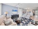 Open living room featuring a TV, sofa, stylish rug, recessed lights, and a view into dining area at 7620 Raptor Ct, North Port, FL 34287