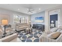 Comfortable living room featuring stylish furnishings, cool-toned walls, ceiling fan, and large window at 7620 Raptor Ct, North Port, FL 34287
