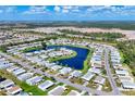 Panoramic aerial view of the community showcasing the homes surrounding a beautiful blue lake at 809 Tangerine Woods Blvd # 215, Englewood, FL 34223