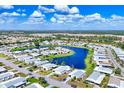 Scenic aerial shot of the community highlighting the beautiful lake and well-maintained properties at 809 Tangerine Woods Blvd # 215, Englewood, FL 34223