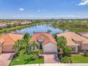 An aerial view of a house with a lake in the background in a beautiful, planned community at 13000 N Marsh Dr, Port Charlotte, FL 33953