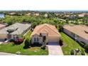Aerial view showcasing a well-maintained single-story home with a red tile roof and lush green lawn at 13217 Scrub Jay Ct, Port Charlotte, FL 33953