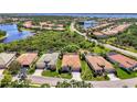 Expansive aerial view of a residential community with waterfront access and meticulously maintained landscapes at 13217 Scrub Jay Ct, Port Charlotte, FL 33953