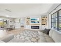 Open concept living area featuring built-in shelving, an electric fireplace, and a view of the dining area at 1365 Sussex Rd, Venice, FL 34293