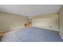 Open-concept living room featuring tile and carpeted floors with a view into the kitchen at 1386 Dewitt St, Port Charlotte, FL 33952