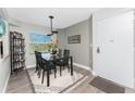 Cozy dining area featuring a glass-top table, modern chairs, and tasteful decor at 1401 S Mccall Rd # A 108, Englewood, FL 34223