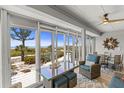 Inviting sunroom with beach views, cozy seating, and bright decor at 17 Seawatch Dr, Boca Grande, FL 33921
