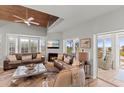 Open living room with fireplace, wood ceiling, comfortable seating and beautiful views at 17 Seawatch Dr, Boca Grande, FL 33921