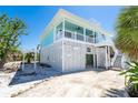 Stilt home featuring ground floor access and bright exterior finish at 180 S Gulf Blvd, Placida, FL 33946