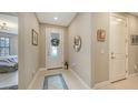 Bright foyer featuring tiled floors, decorative accents, and a stylish front door at 2117 Laurifolia Ct, North Port, FL 34289