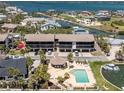 Exterior showcasing the building with a community pool and boat docks for waterfront living at 2769 N Beach Rd # 105, Englewood, FL 34223