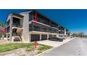Exterior view of the building, highlighting garage parking and screened balconies at 2769 N Beach Rd # 105, Englewood, FL 34223
