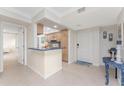 Kitchen showcases cozy wooden cabinets, tile backsplash, and a breakfast bar, blending functionality with coastal charm at 2955 N Beach Rd # D113, Englewood, FL 34223